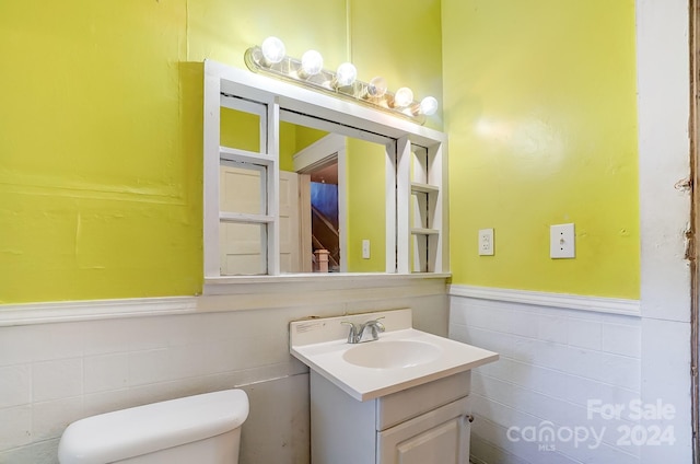 bathroom with toilet and vanity