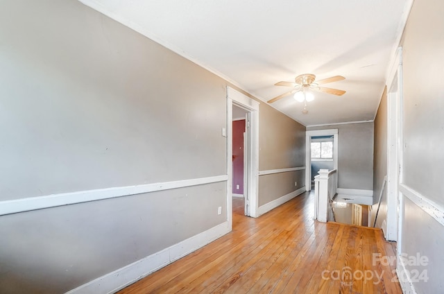 empty room featuring light wood-type flooring and ceiling fan