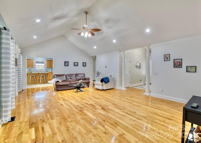 living room featuring ornate columns, ceiling fan, lofted ceiling, and light wood-type flooring