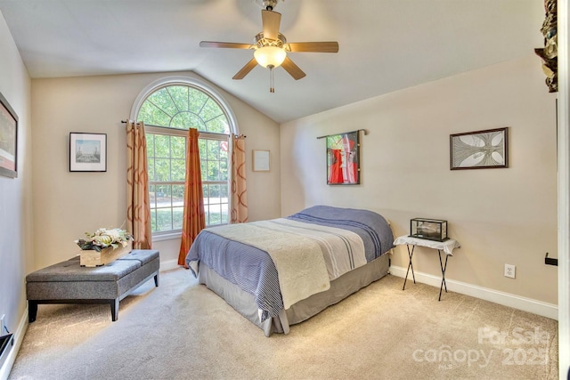 bedroom with ceiling fan, vaulted ceiling, and light carpet