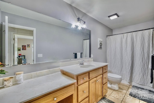 bathroom featuring vanity, toilet, and tile patterned flooring