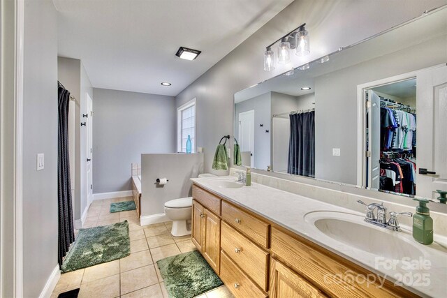 5692 Marblestone Dr, Granite Falls, NC 28630 - bathroom featuring tile patterned floors, double vanity, a bath, a shower with curtain, and a walk in closet