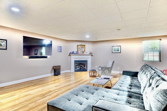 5692 Marblestone Dr, Granite Falls, NC 28630 - living area with wood finished floors, a glass covered fireplace, baseboards, and recessed lighting