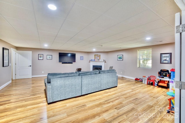 5692 Marblestone Dr, Granite Falls, NC 28630 - living room with light wood-style floors, a fireplace, recessed lighting, baseboards, and a drop ceiling