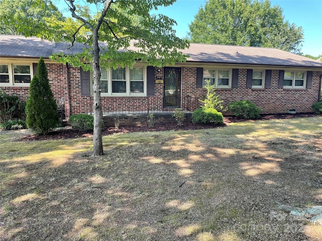 ranch-style home with a front lawn