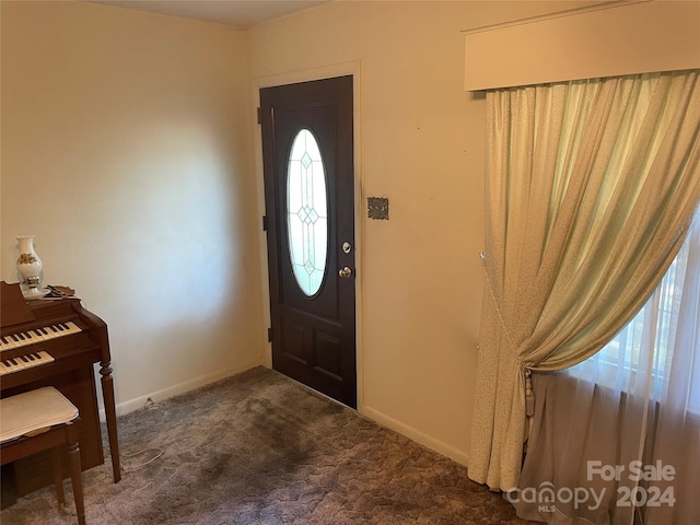 foyer featuring dark carpet