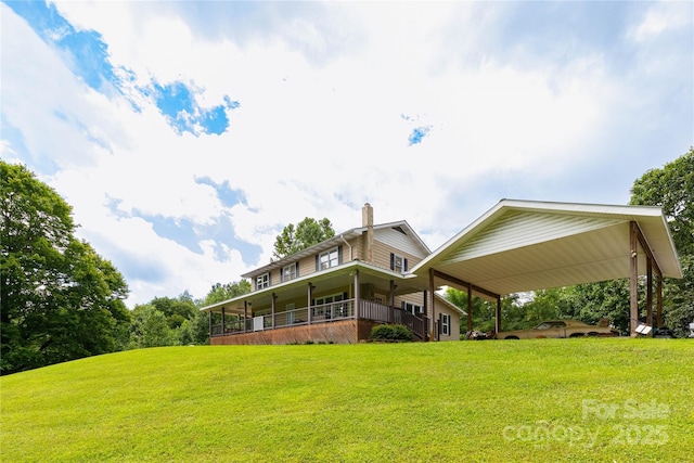 back of property with a yard and covered porch