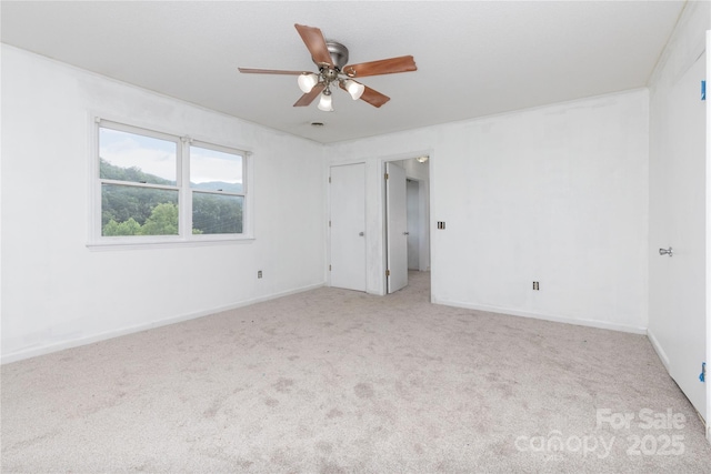 carpeted empty room with ceiling fan