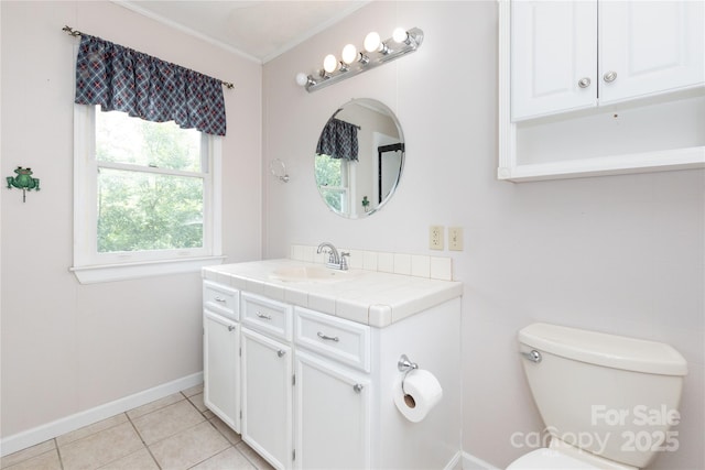 bathroom with crown molding, vanity, toilet, and tile patterned flooring