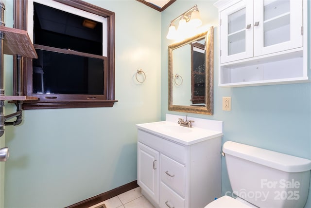 bathroom featuring tile patterned flooring, vanity, and toilet