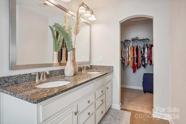 bathroom with tile patterned flooring and vanity