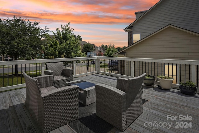 deck at dusk with outdoor lounge area