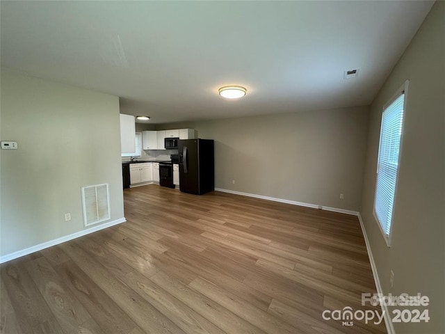 unfurnished living room featuring light hardwood / wood-style flooring