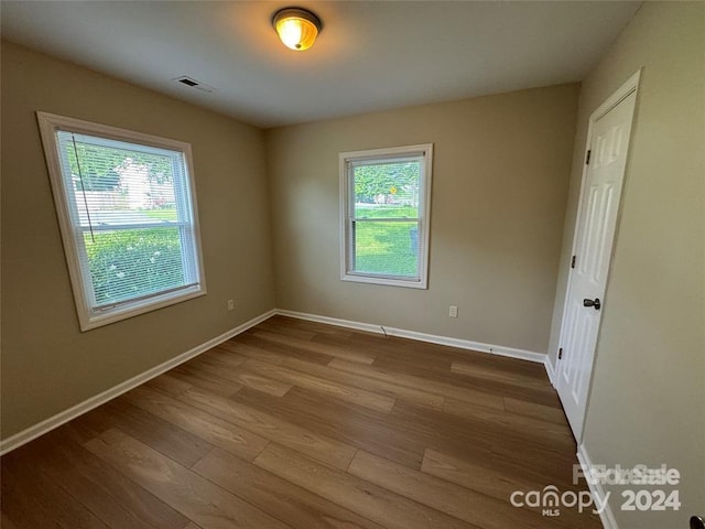 empty room with wood-type flooring