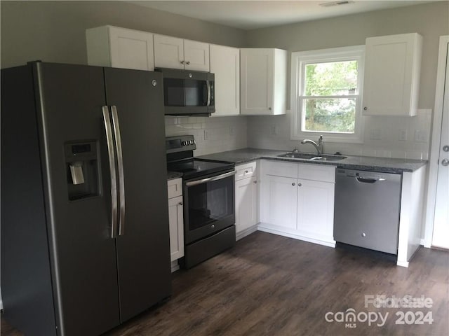 kitchen featuring white cabinetry, sink, dark wood-type flooring, stainless steel appliances, and stone countertops