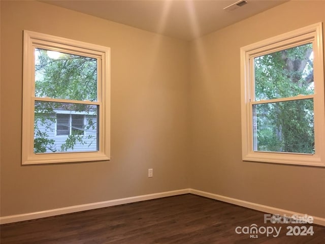 empty room with dark wood-type flooring