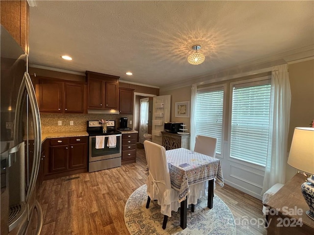 dining space with ornamental molding and light wood-type flooring