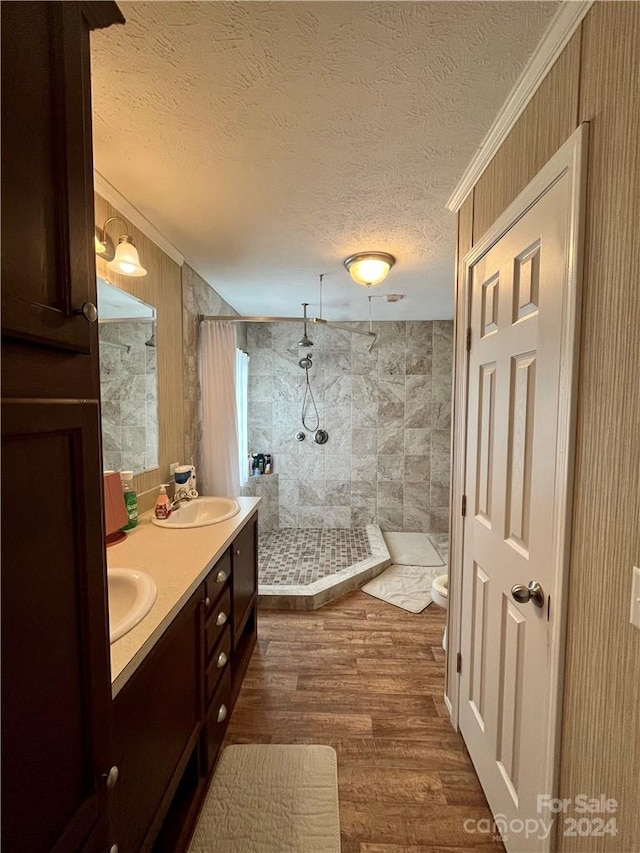 bathroom with walk in shower, toilet, wood-type flooring, crown molding, and a textured ceiling