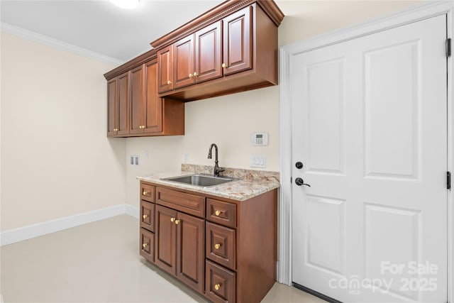 kitchen featuring ornamental molding and sink