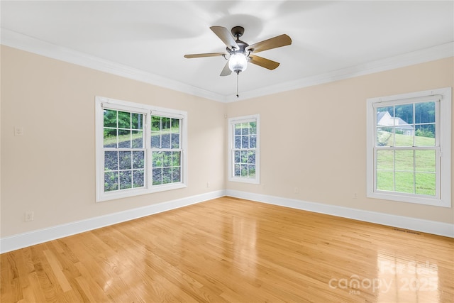 spare room featuring ceiling fan, crown molding, and light hardwood / wood-style floors