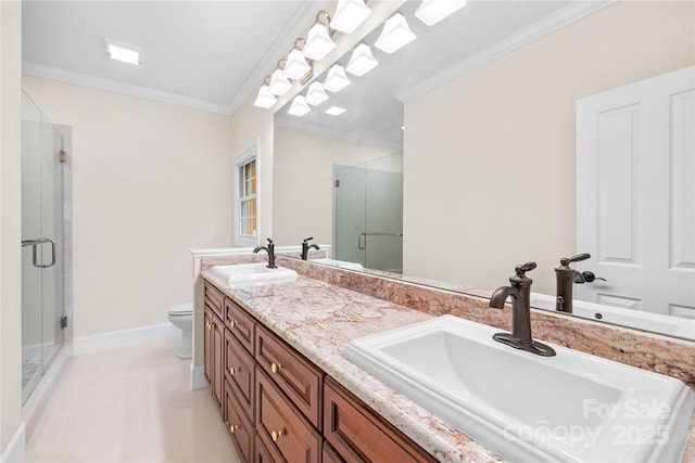 bathroom with tile patterned floors, vanity, toilet, a shower with shower door, and crown molding