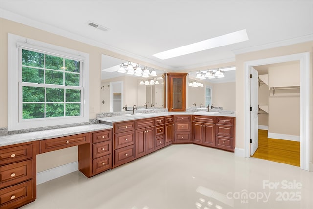 bathroom featuring vanity, tile patterned flooring, and ornamental molding