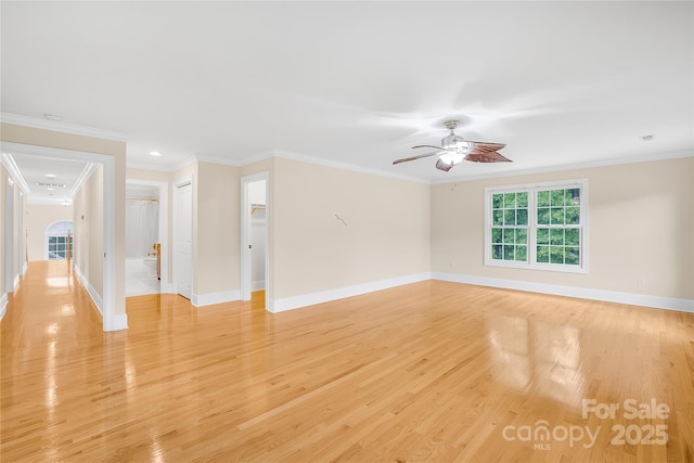 unfurnished room featuring ceiling fan, crown molding, and light hardwood / wood-style floors