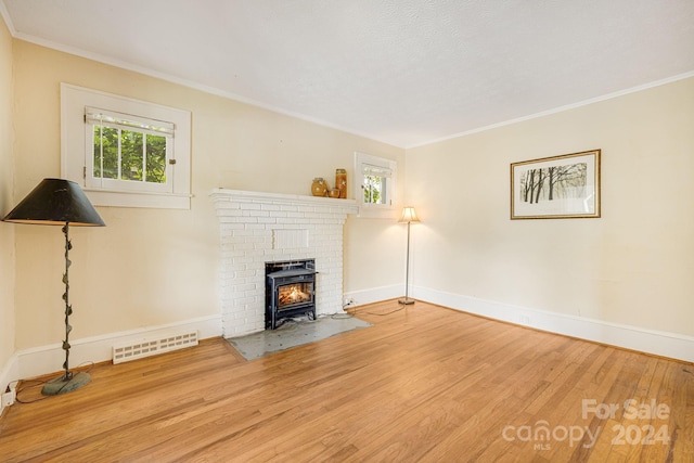 unfurnished living room with light hardwood / wood-style flooring and ornamental molding