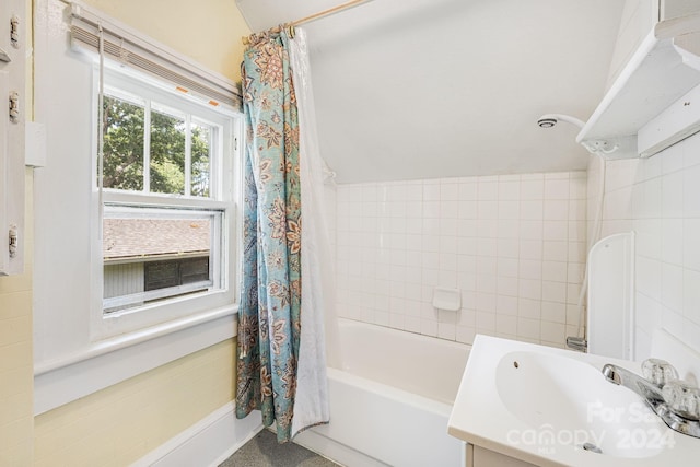 bathroom with shower / bath combo with shower curtain and vanity