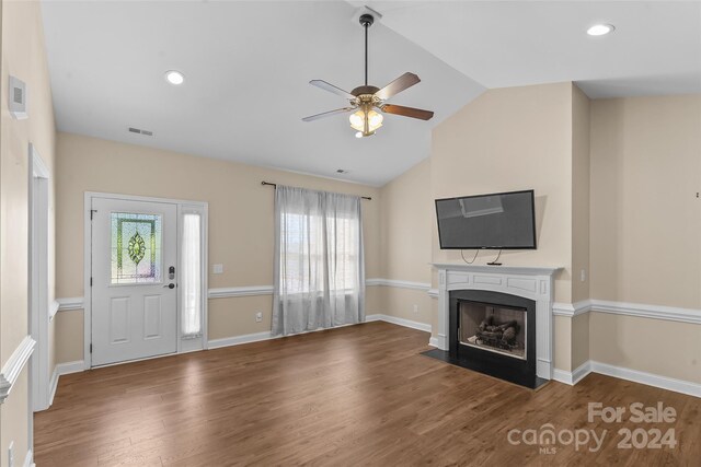 unfurnished living room with dark hardwood / wood-style flooring, lofted ceiling, and ceiling fan