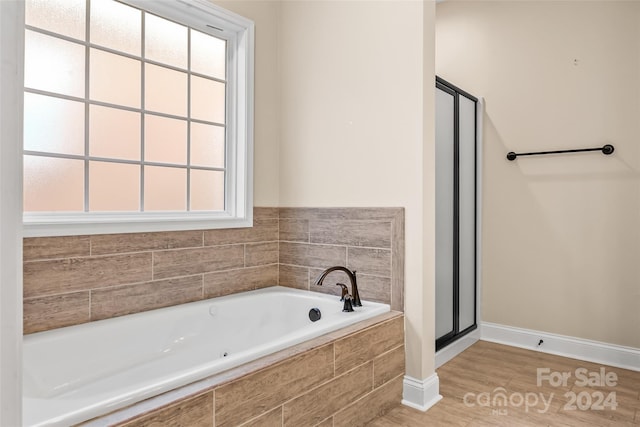 bathroom featuring shower with separate bathtub