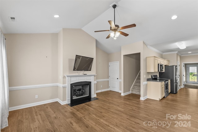 unfurnished living room featuring light wood-type flooring, ceiling fan, vaulted ceiling, and crown molding