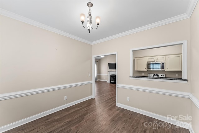 unfurnished dining area featuring an inviting chandelier, dark wood-type flooring, and crown molding