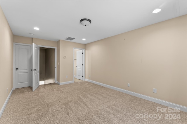 unfurnished bedroom featuring light colored carpet