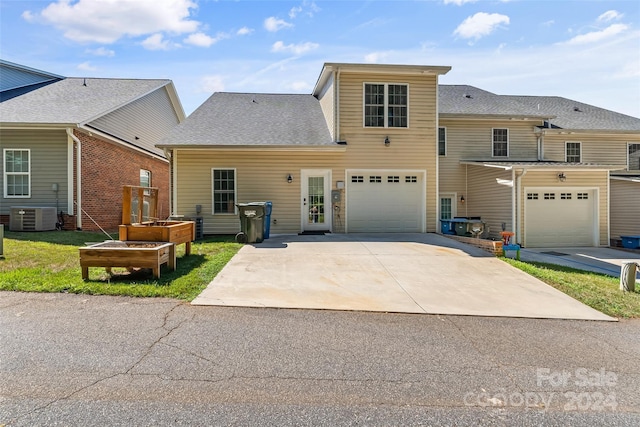 view of front of house featuring central AC unit and a garage