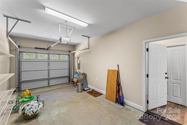 garage featuring electric panel and a garage door opener