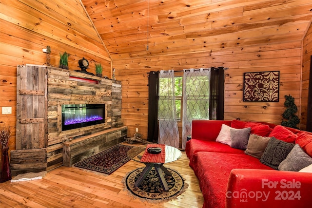 living room featuring a fireplace, wood ceiling, wooden walls, and hardwood / wood-style floors