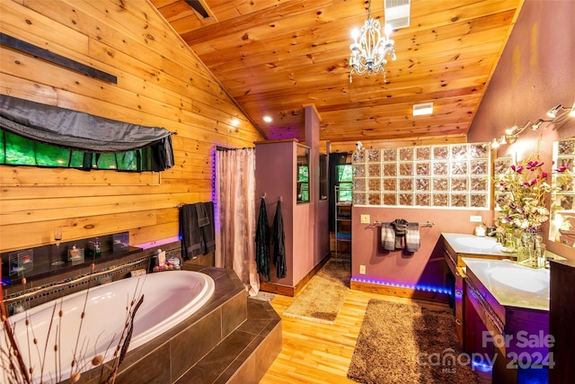 bathroom with an inviting chandelier, wooden ceiling, wood-type flooring, vaulted ceiling, and shower with separate bathtub