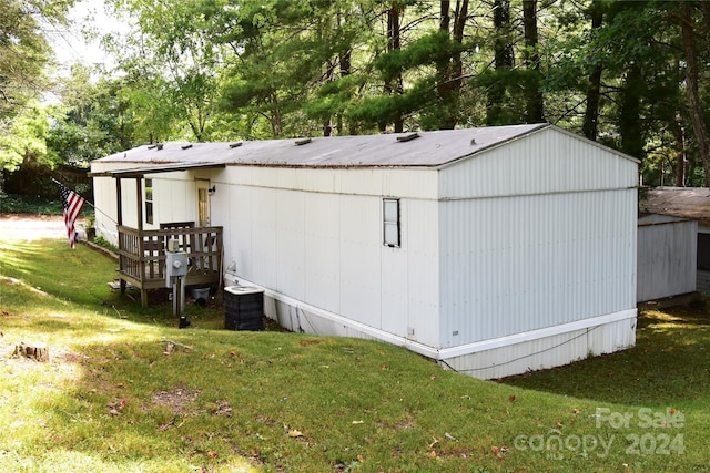 exterior space with a lawn and central AC