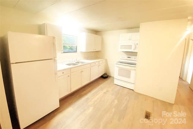 kitchen featuring white cabinetry, sink, white appliances, and light wood-type flooring