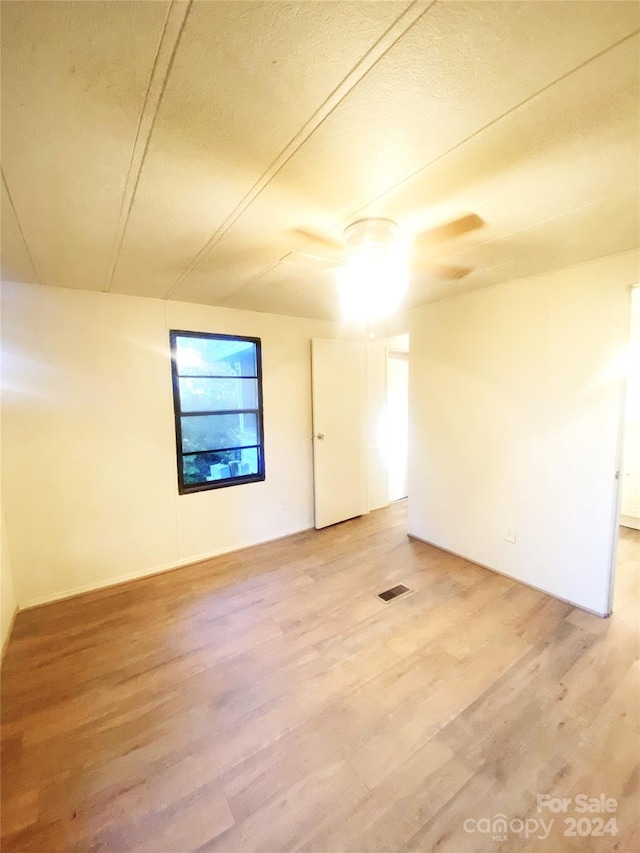 interior space with ceiling fan and hardwood / wood-style flooring