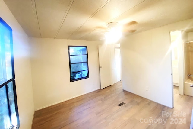 spare room with ceiling fan and light hardwood / wood-style flooring