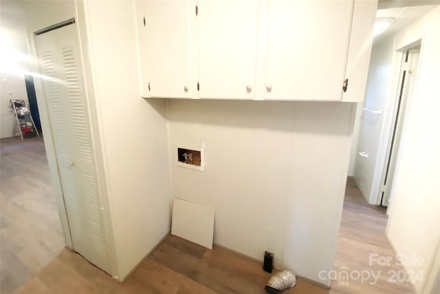 laundry area featuring cabinets, washer hookup, and light hardwood / wood-style flooring