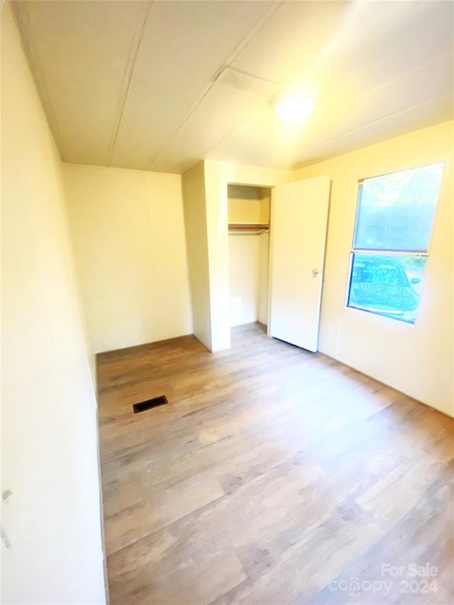 unfurnished room with hardwood / wood-style floors