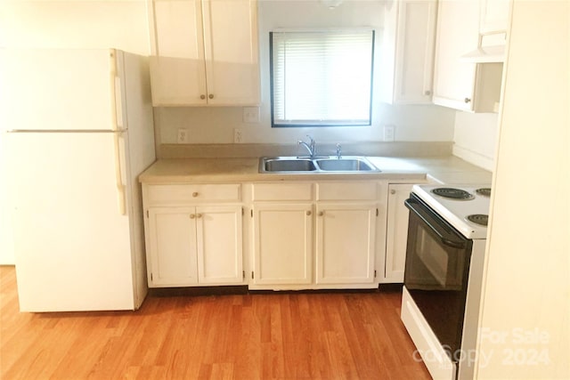 kitchen with electric stove, exhaust hood, sink, white cabinets, and white refrigerator