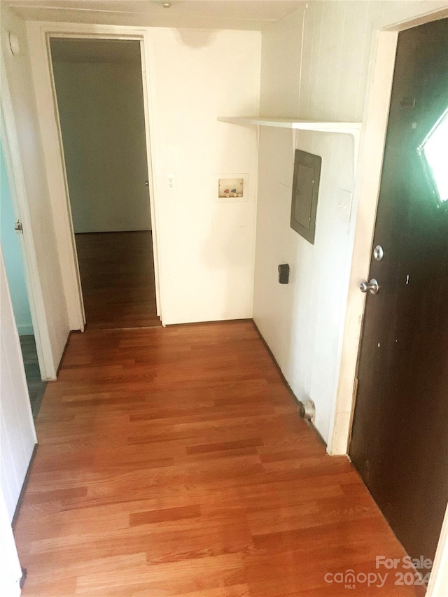 hallway featuring electric panel and wood-type flooring