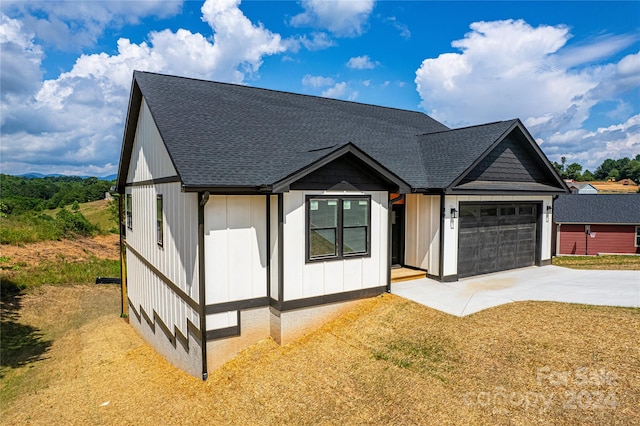 view of front of home with a garage and a front lawn