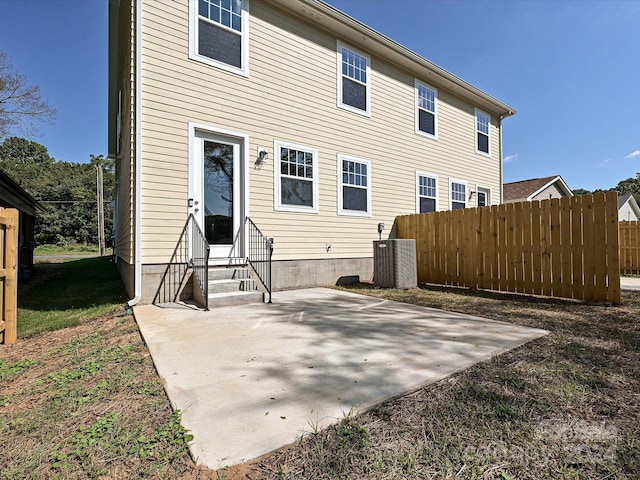 back of property featuring cooling unit and a patio area