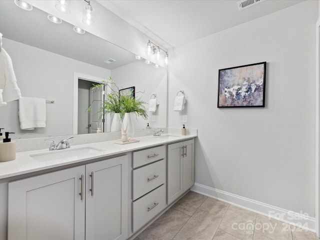 bathroom featuring tile patterned flooring and vanity