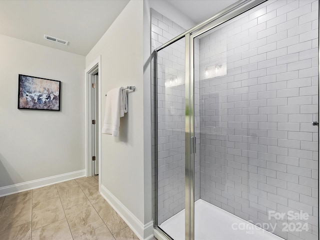 bathroom featuring a shower with shower door